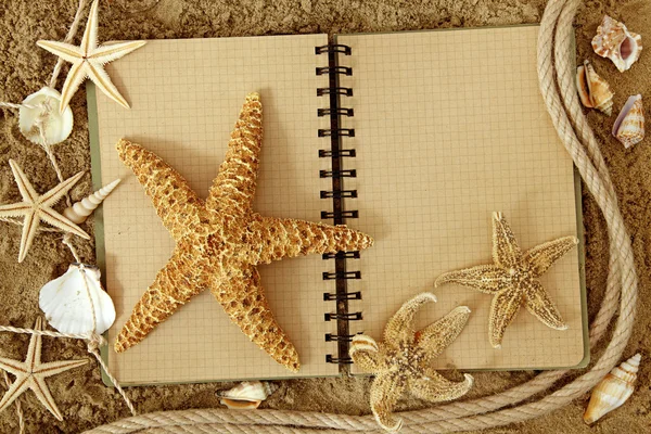 Exercise book and sea stars — Stock Photo, Image