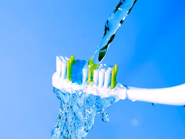 Toothbrush under the running water — Stock Photo, Image