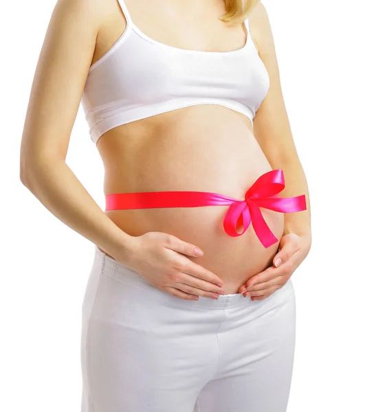 Pregnant woman with pink ribbon on belly isolated on white — Stock Photo, Image