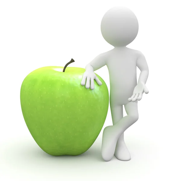 Человек опирается на огромное зеленое яблоко — стоковое фото