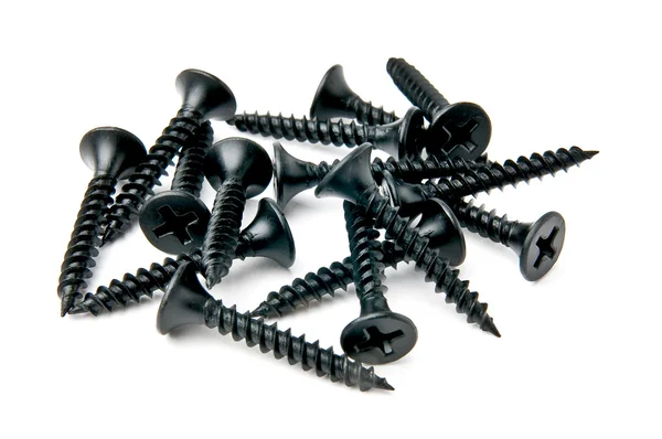 Isolated small handful of black screws on white background — Stock Photo, Image