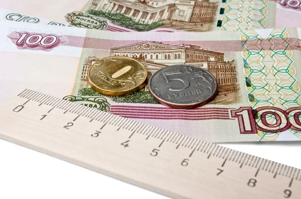 Coins, banknotes and a ruler — Stock Photo, Image