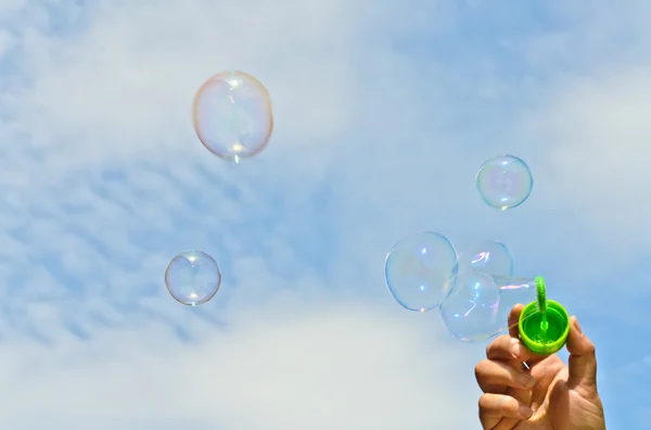 stock image A little boy blows bubbles