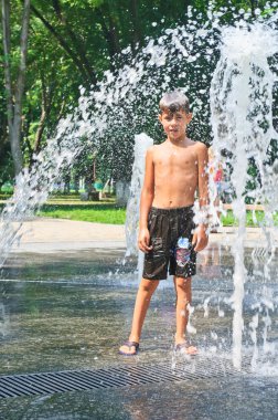 The boy is bathed in the fountain clipart