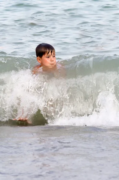 Boy playing in the surf — Stock Photo, Image