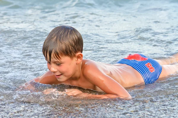 Boy playing in the surf — Stock Photo, Image
