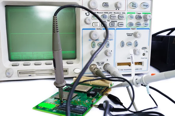 Oscilloscope and the board on a white background — Stock Photo, Image