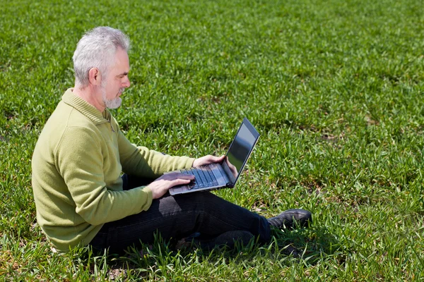 Grandfather with a laptop — Stock Photo, Image