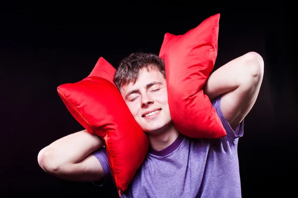 Человек спит между двумя подушками — стоковое фото