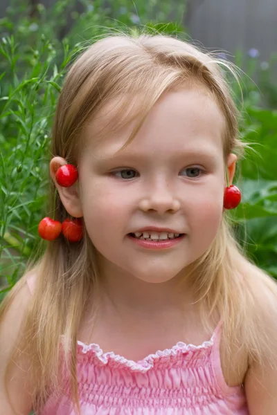 Beautiful little girl with earrings made of berries — Stock Photo, Image