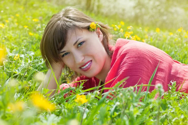 stock image Young woman lying on grass