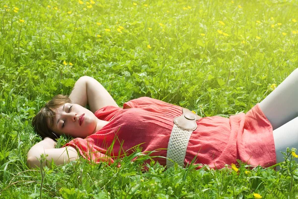 stock image Beautiful girl lying in the grass