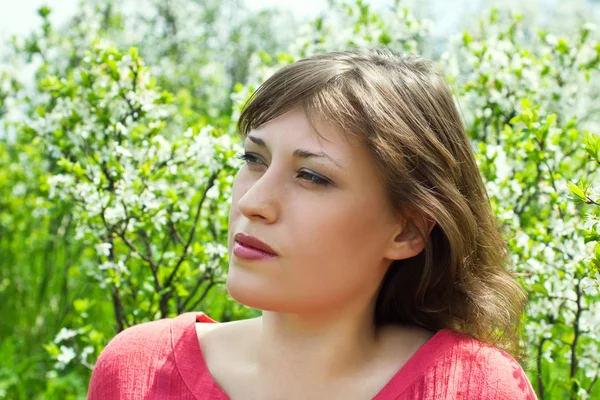 stock image Beautiful girl in a flowered garden