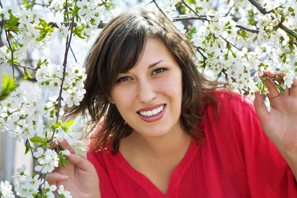 Stock image Beautiful girl in a flowered garden