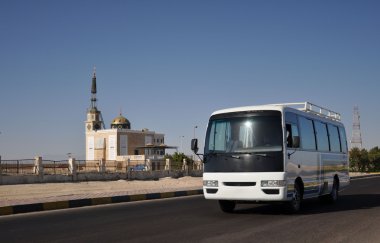 Buses on the background of the mosque. clipart