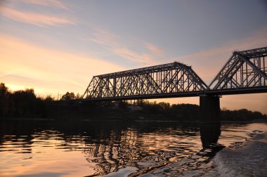 Railroad bridge. Evening glow . clipart