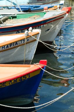 Traditional greek fishing boats in harbour clipart