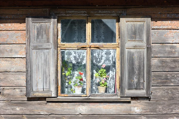 stock image Window of an old house with flowers