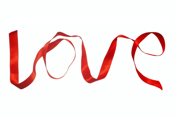 Słowo miłość z czerwoną wstążką — Zdjęcie stockowe