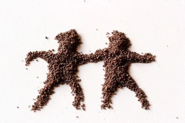 Pequeñas figuras del hombre hechas en polvo de chocolate —  Fotos de Stock