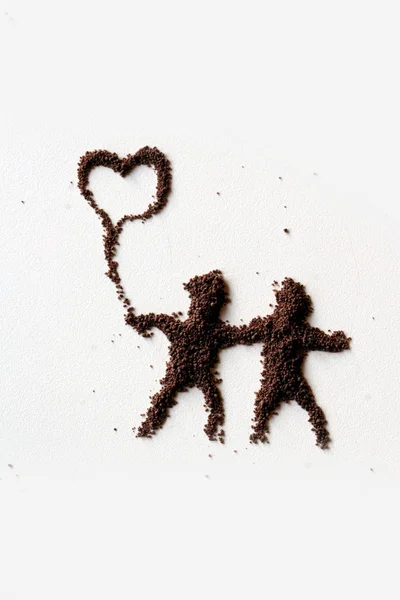 Μικρές φιγούρες των ανθρωπογενών σε σκόνη σοκολάτας — Φωτογραφία Αρχείου