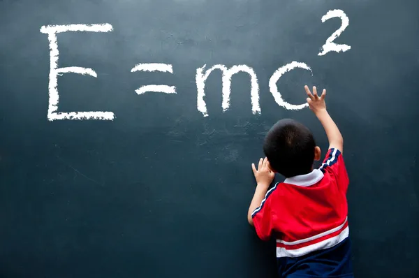 Boy drawing Formula on the wall — Stock Photo, Image