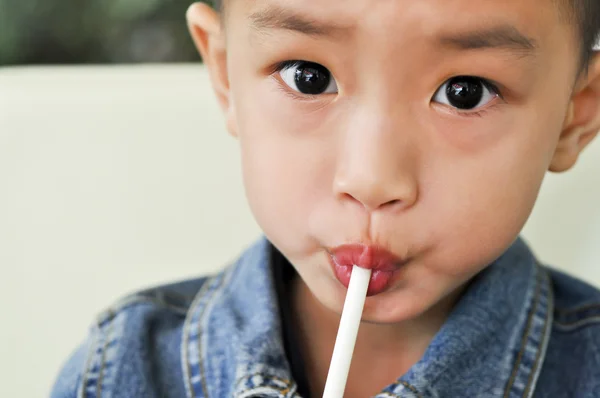 Stock image The boy with the straw