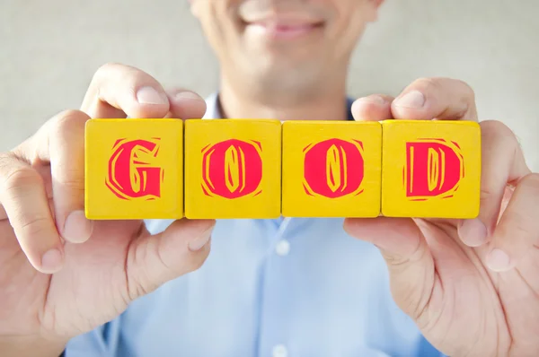 Salesman took the building blocks to express the meaning of good — Stock Photo, Image
