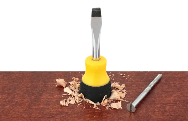 Screwdriver with screw on wood — Stock Photo, Image