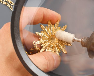 The jeweler polishing gold clipart