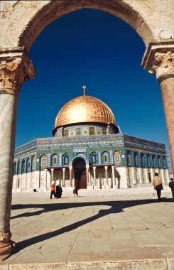 The afternoon sun shines on the golden Dome of the Rock and chur clipart