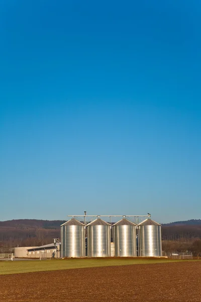 Beautiful landscape with silo and field with blue sky — Stock Photo, Image