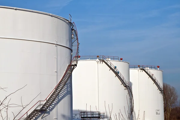 White tanks in tank farm with blue sky Stock Picture