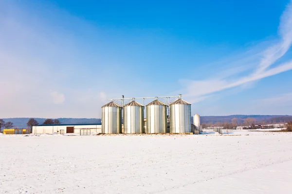 Silo in de winter met sneeuw en blauwe hemel — Stockfoto