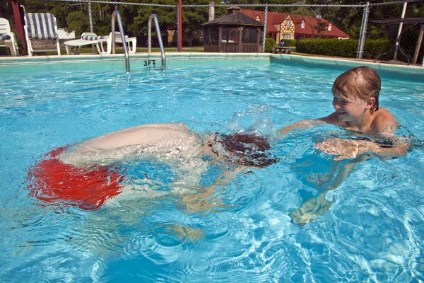 Los hermanos se divierten en la piscina al aire libre — Foto de Stock
