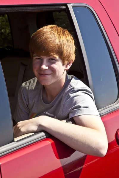 Smiling boy in the rear of the car — Stock Photo, Image