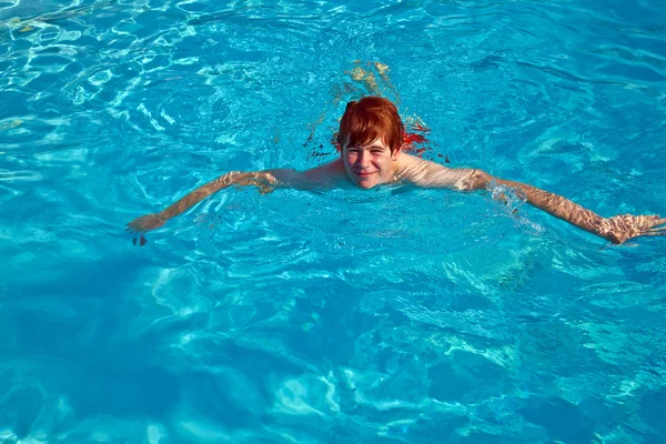 Barnet simmar i poolen — Stockfoto