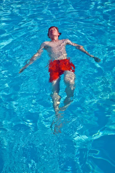 Chico se divierte en la piscina al aire libre — Foto de Stock