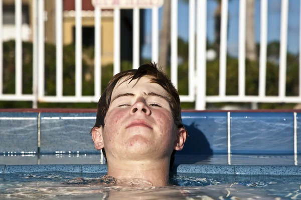 Fiú pihentető a medence szélén — Stock Fotó