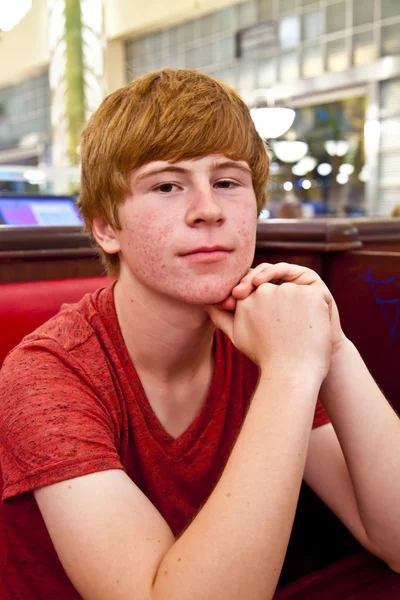 Attractive boy sitting in a diners at night — Stock Photo, Image
