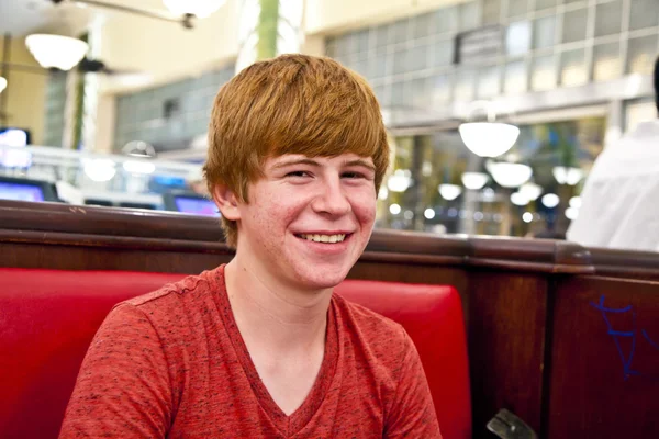 Attractive boy sitting in a diners at night — Stock Photo, Image
