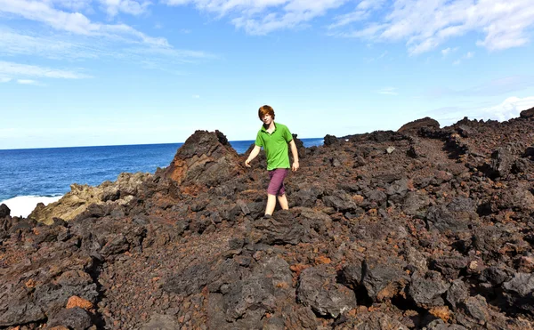 Boy walking in volcanic area — Stock Photo, Image