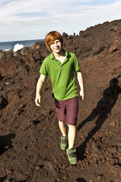 Boy walking in volcanic area — Stock Photo, Image