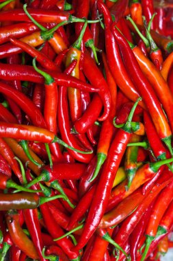 Fresh chili pepper in different colors at the herb market clipart