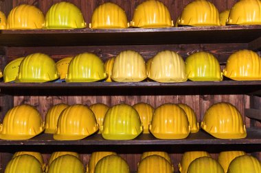 Yellow helmets for visitors at the gem mine clipart