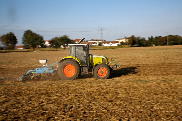 Трактор вспахивает поле — стоковое фото