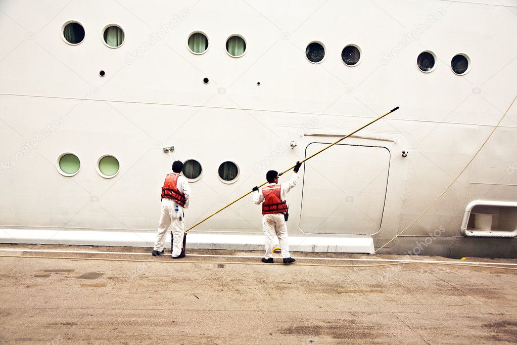 Workers are painting the ships body
