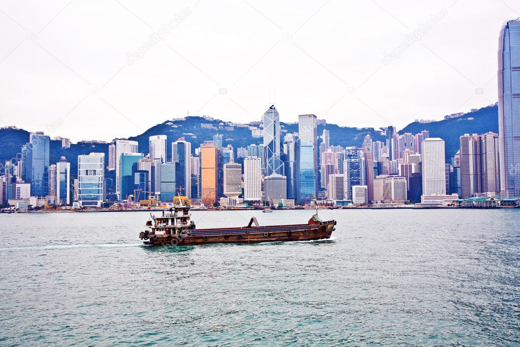 Landscape of Victoria Harbor in Hong Kong with junk boat on the
