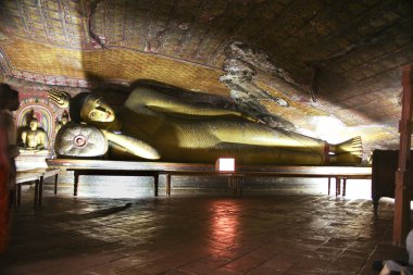 Figures of Buddha Inside of Rock Temple in Dambulla clipart