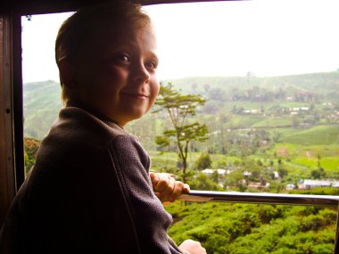 Boy enjoying the scenic ride in Sri lanka clipart